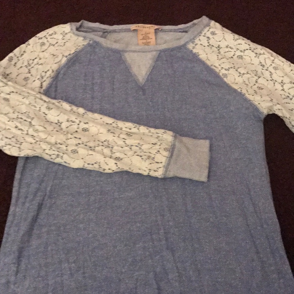 A blue long sleeve with white flowery sleeves